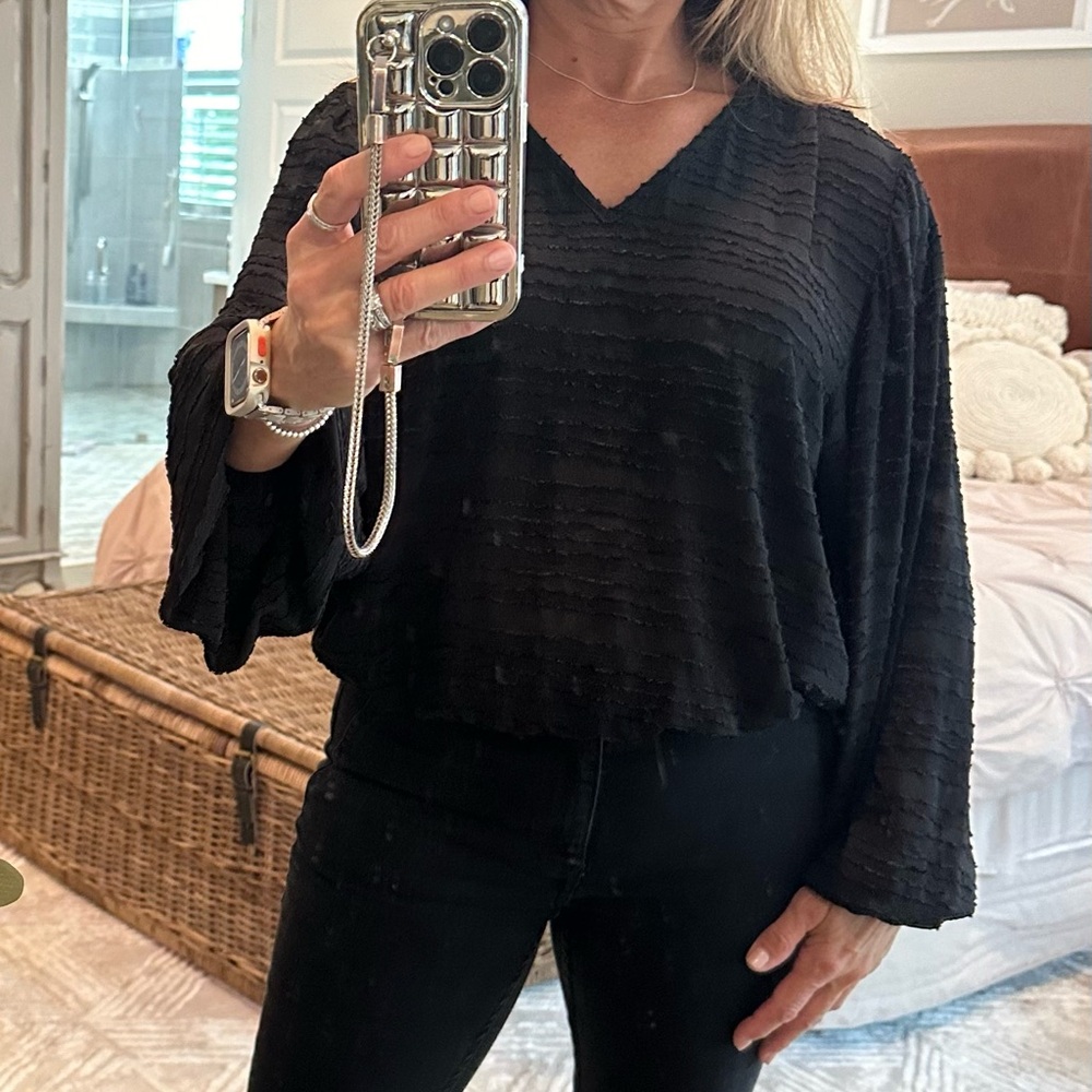 Black patterned blouse with puff sleeves and elastic band at waist